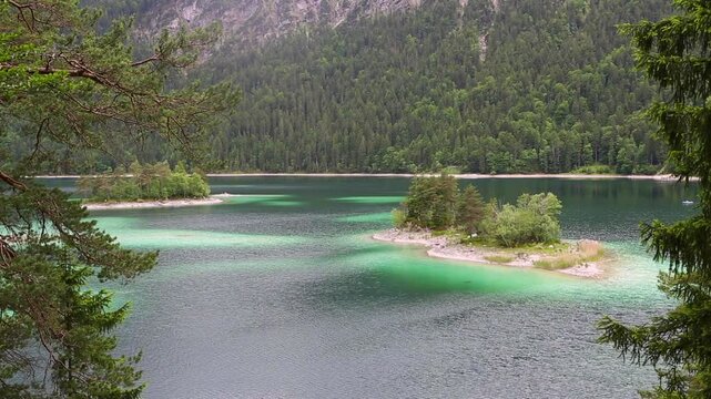 Small island at Eibsee, mountain lake in Bavaria, Zugspitze mountain, Germany