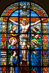 Stained glass (19th century) of Jesus Christ crucified on the cross represented with Marie and Saint John.