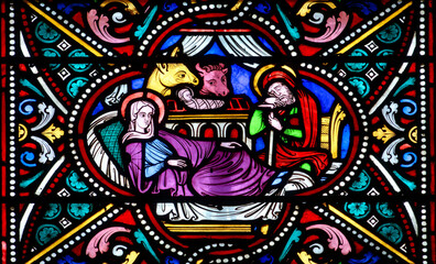 Fototapeta premium Stained glass (Nineteenth century) of Christmas Nativity Scene with Virgin Mary, Saint Joseph, and Jesus baby.