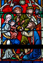 Fototapeta premium Stained glass (17th century) of Christmas Nativity Scene : Adoration of the Magi as they present gifts of gold, frankincense and myrrh to the Infant Jesus.