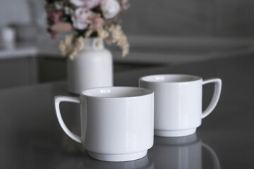 Elegant teacups on tray in luxury hotel room, morning tea service with porcelain cups against cozy...
