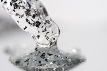 Close-up cosmetic dropper with hyaluronic serum, skincare treatment detail