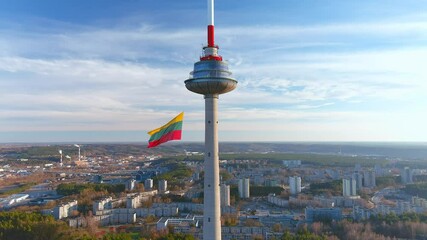 Giant tricolor Lithuanian flag waving on Vilnius television tower on the celebration of restoration of Independence of Lithuania on the 11th of March. Static view.