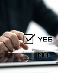 Closeup image man hand select yes on check box. Choosing between option, positive decision concept