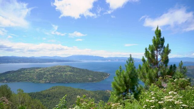 Lake Toba with a foreground of trees. Lake Toba is a large natural lake in North Sumatra