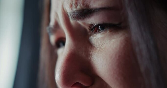 Close up a girl closes her eyes and cries her face