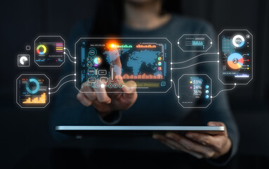 Naklejka premium A person interacts with a digital interface displaying data visuals and analytics on a tablet, showcasing technology and innovation in data management.