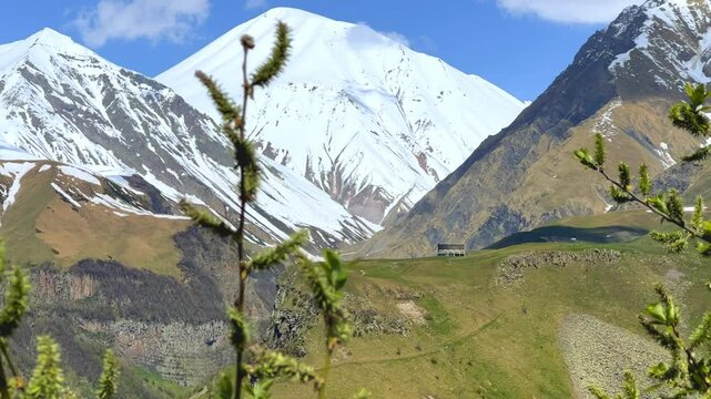 GUDAURI, GEORGIA - APRIL 26, 2024: Scenic view of the Devil's Gorge and the Arch of Friendship. The Caucasus Mountains in the area of the Peoples' Friendship Arch on the Georgian Military Road. 4K