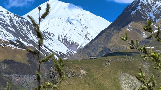 GUDAURI, GEORGIA - APRIL 26, 2024: Scenic view of the Devil's Gorge and the Arch of Friendship. The Caucasus Mountains in the area of the Peoples' Friendship Arch on the Georgian Military Road. 4K