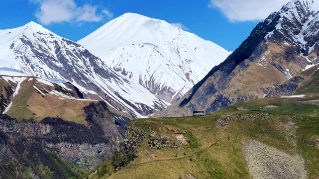 GUDAURI, GEORGIA - APRIL 26, 2024: Scenic view of the Devil's Gorge and the Arch of Friendship. The Caucasus Mountains in the area of the Peoples' Friendship Arch on the Georgian Military Road. 4K