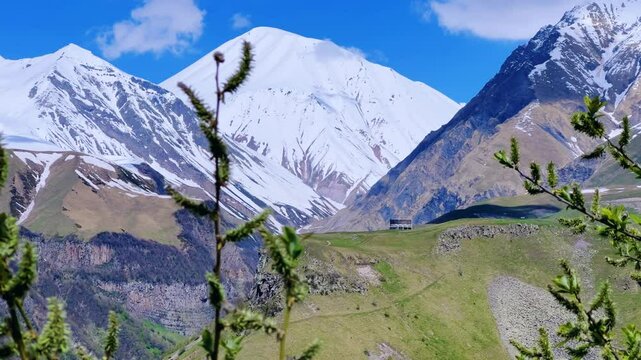 GUDAURI, GEORGIA - APRIL 26, 2024: Scenic view of the Devil's Gorge and the Arch of Friendship. The Caucasus Mountains in the area of the Peoples' Friendship Arch on the Georgian Military Road. 4K