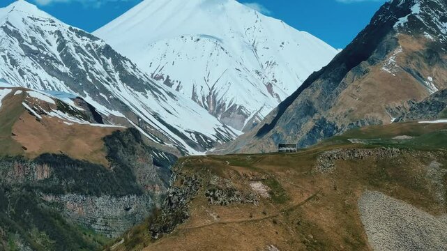 GUDAURI, GEORGIA - APRIL 26, 2024: Scenic view of the Devil's Gorge and the Arch of Friendship. The Caucasus Mountains in the area of the Peoples' Friendship Arch on the Georgian Military Road. 4K