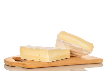 Pieces of fragrant brie cheese on a bamboo cutting board isolated on a white background, close-up.