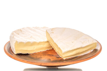 Pieces of fragrant brie cheese on a clay plate isolated on a white background, close-up.