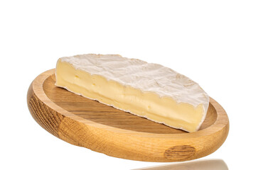 Pieces of fragrant brie cheese on a wooden plate isolated on a white background, close-up.