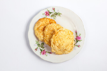 sweet crackers (emping melinjo) on a plate isolated on white background