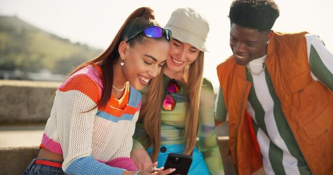 Bridge, conversation and phone with friends in city together to relax for summer bonding. App, diversity or meme with funny man and woman group laughing or talking outdoor in urban town for break