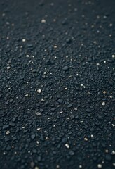 Dark, coarse-grained asphalt surface, showing texture and small stones, coarse, asphalt, street