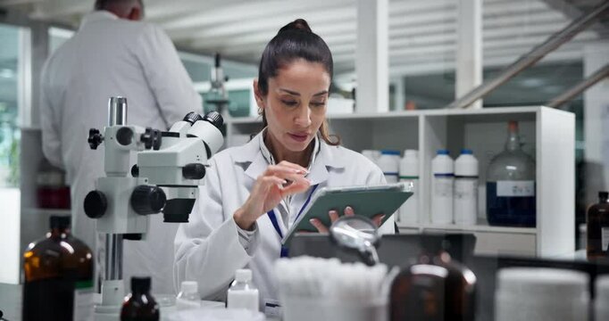 Scientist, woman and microscope at laboratory with tablet, test and review for results in medical research. Person, app and clinical trial for pharmaceuticals, perspective and solution by computer - Powered by Adobe