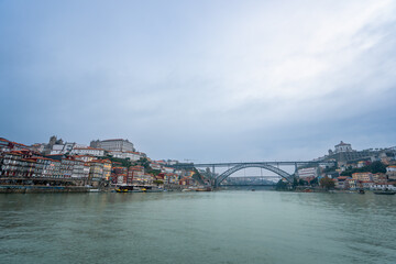 A picturesque view of Porto's colorful riverside buildings and the iconic Dom Luis I Bridge...
