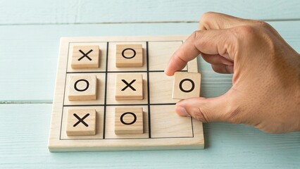 hand placing o on tic tac toe game board