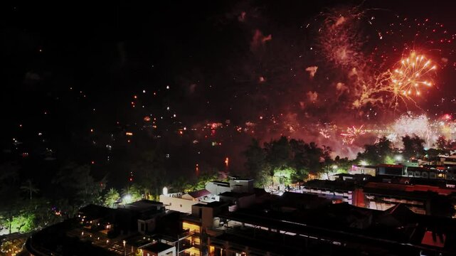 Celebratory fireworks display urban cityscape nighttime event festive environment aerial viewpoint vibrant atmosphere for spectacular occasions