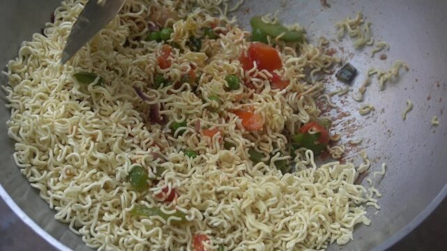 Boil water, add Maggi noodles and seasoning, cook for 2 minutes, stir well, and enjoy a quick, tasty meal.