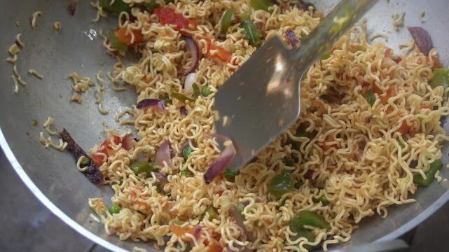 Boil water, add Maggi noodles and seasoning, cook for 2 minutes, stir well, and enjoy a quick, tasty meal.