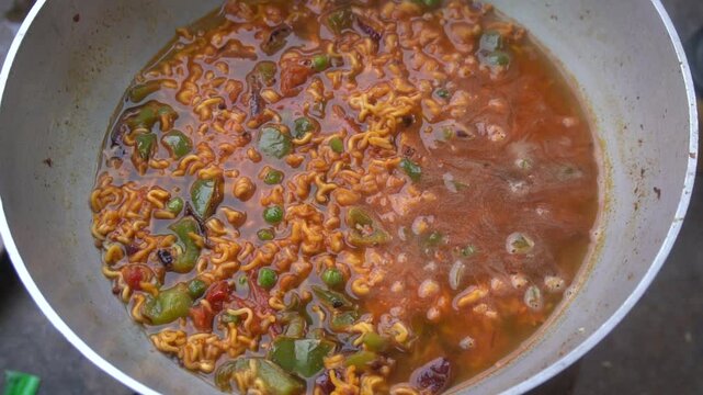 Boil water, add Maggi noodles and seasoning, cook for 2 minutes, stir well, and enjoy a quick, tasty meal.