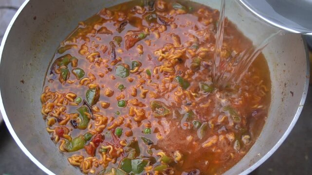Boil water, add Maggi noodles and seasoning, cook for 2 minutes, stir well, and enjoy a quick, tasty meal.