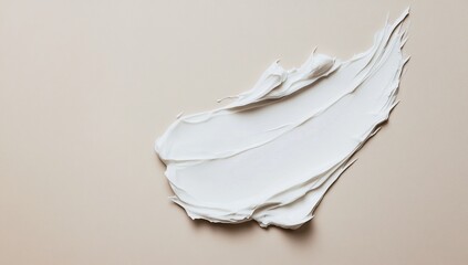 Creamy, smooth cosmetic texture.  A soft, white substance spread on a beige surface
