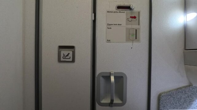Jakarta, Indonesia - March 10, 2025: The door to the airplane toilet