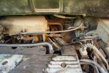 Top view of the dirty engine of an old car in need of repair. Car engine maintenance. Selective focus. Close-up,