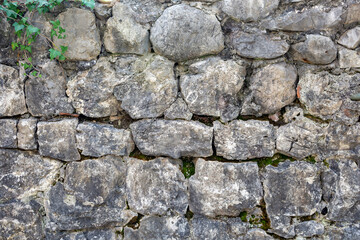 Stone wall background texture. Building facade, High fence made of stone blocks