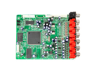 A close-up of the processor microchip surrounded by other electrical components on a green circuit...