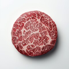 Top-down view of raw marbled ribeye steak with rich fat texture on white