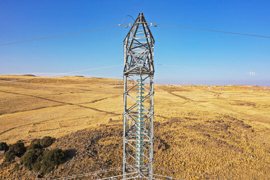 AERIAL VIEW OF CONSTRUCTION AND MAINTENANCE OF HIGH VOLTAGE TOWERS - Powered by Adobe