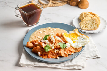 Traditional Mexican chilaquiles with red sauce, authentic mexican breakfast