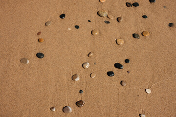 Looking down at the stones being washed up on the beach by Lake Michigan at Kohler-Andrae State Park, Sheboygan, Wisconsin