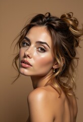 Fototapeta premium A beautiful young woman with a messy bun in her hair