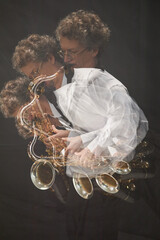 Image with triple exposure of concentrated male saxophonist improvising on wind instrument creating...