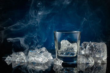 Crystal clear vodka or gin in a glass with ice.