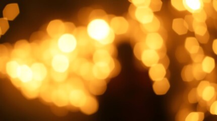 Obraz premium Golden bokeh lights, dark scene, blurred figure