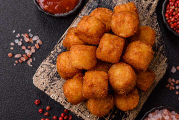 Cheese or potato croquettes, balls fried in breading with salt, spices