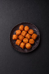 Cheese or potato croquettes, balls fried in breading with salt, spices