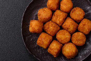 Cheese or potato croquettes, balls fried in breading with salt, spices
