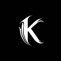 Stylized letter K with elegant curves and sharp lines against a black background representing modern design and creativity