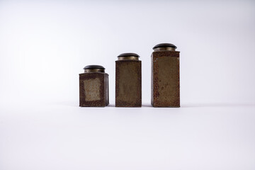 Vintage tin spice cans in a line on a whte background