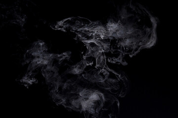 Smoke curling on a black background