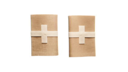 Two tan boxes wrapped with white cross shaped ribbon on  in studio lighting on transparent background png